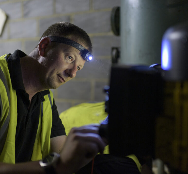 Engineer inspecting pump system